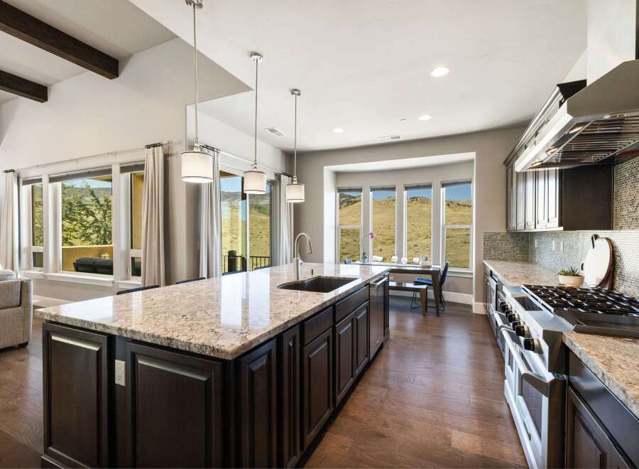 This stunning kitchen boasts a spacious island with a granite countertop, perfect for meal preparation and entertaining.