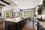 This stunning kitchen boasts a spacious island with a granite countertop, perfect for meal preparation and entertaining.