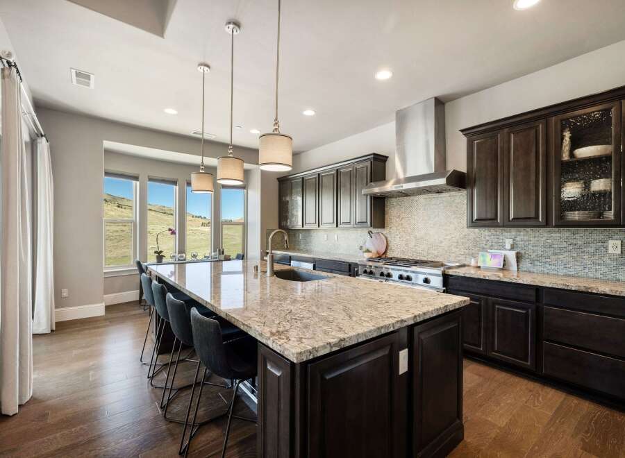 This stunning kitchen boasts a large island with a granite countertop, perfect for meal prep and entertaining.
