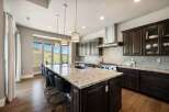 This stunning kitchen boasts a large island with a granite countertop, perfect for meal prep and entertaining.