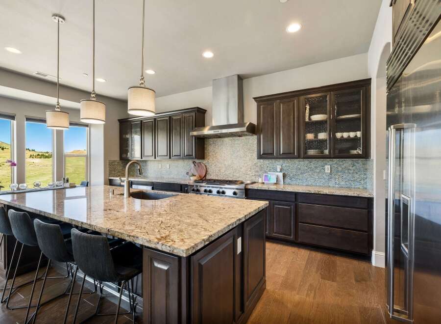 This stunning kitchen boasts a spacious island with a granite countertop, perfect for meal prep and entertaining.