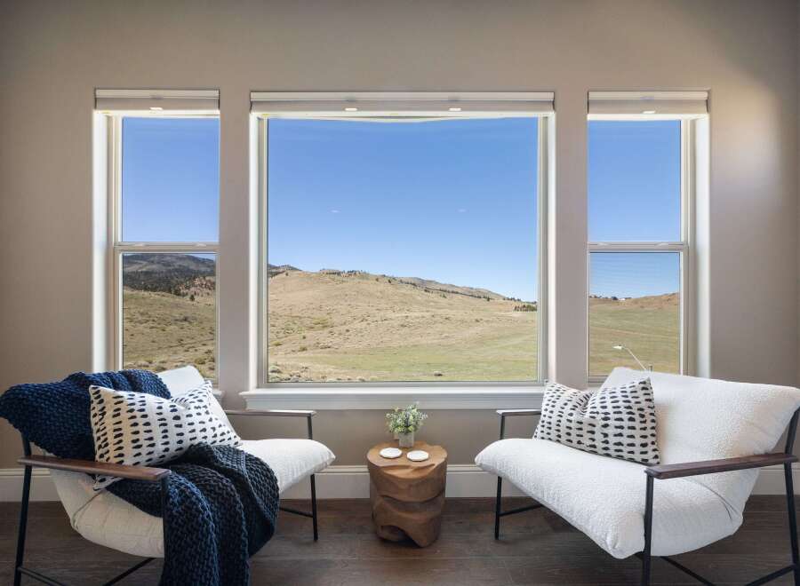 Enjoy breathtaking views from this stunning property! This home features a bright and airy living space with large windows that frame the picturesque landscape.