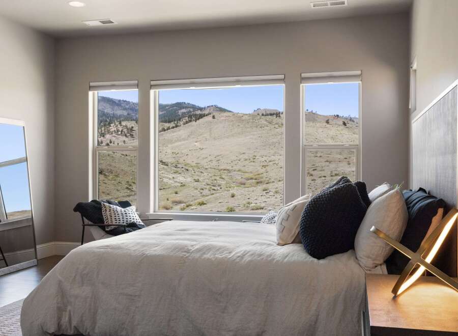 Experience breathtaking views from this stunning bedroom.