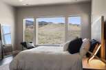 Experience breathtaking views from this stunning bedroom.