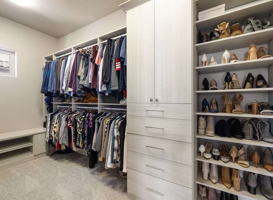 Step into luxury with this meticulously designed walk-in closet, offering ample storage and organization.