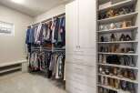 Step into luxury with this meticulously designed walk-in closet, offering ample storage and organization.