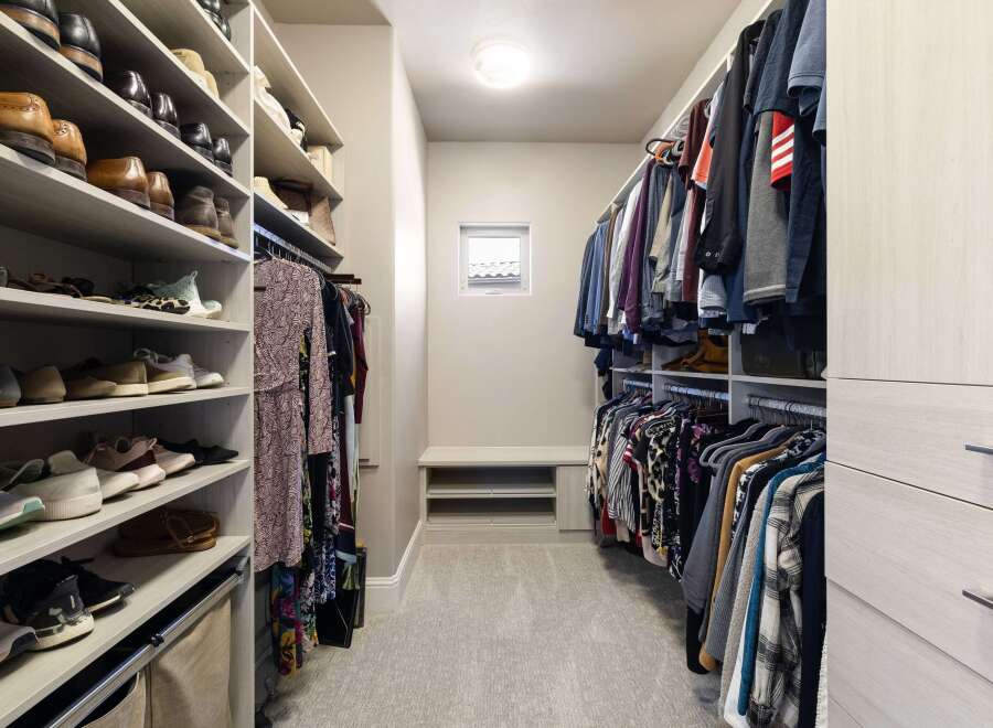 Step into luxury with this meticulously designed walk-in closet, offering ample space and organization for your wardrobe.