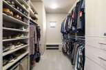 Step into luxury with this meticulously designed walk-in closet, offering ample space and organization for your wardrobe.