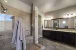 Step into luxury with this stunning bathroom featuring a spacious walk-in shower with glass doors and elegant tile work.