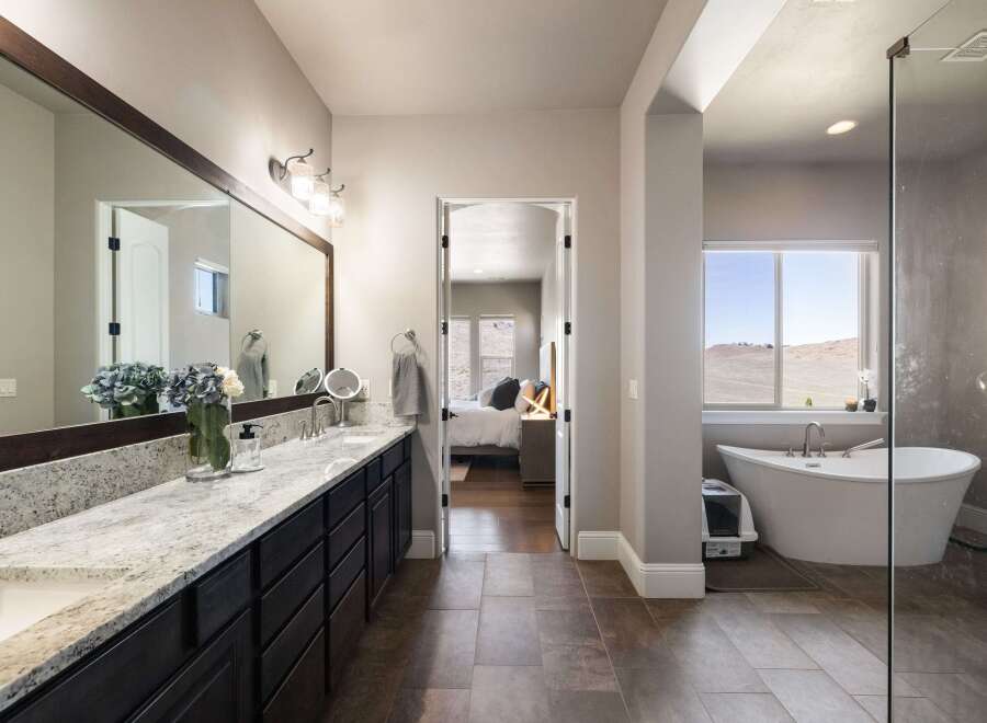 Step into luxury with this stunning bathroom! Featuring a sleek vanity, a spacious soaking tub, and a separate shower, this space is designed for relaxation.