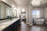 Step into luxury with this stunning bathroom! Featuring a sleek vanity, a spacious soaking tub, and a separate shower, this space is designed for relaxation.