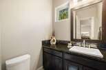 This stunning bathroom boasts a modern design with a sleek vanity and a beautiful granite countertop.