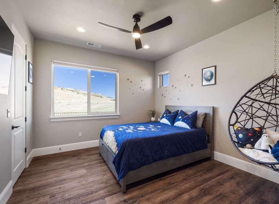 This stunning bedroom boasts a modern design with a touch of whimsy, perfect for a child or space enthusiast.