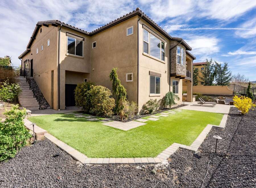 This stunning property boasts a modern exterior with a beautifully landscaped yard.