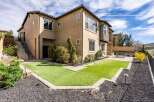 This stunning property boasts a modern exterior with a beautifully landscaped yard.