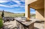 Enjoy outdoor living at its finest with this stunning property featuring a built-in grill and a spacious patio.