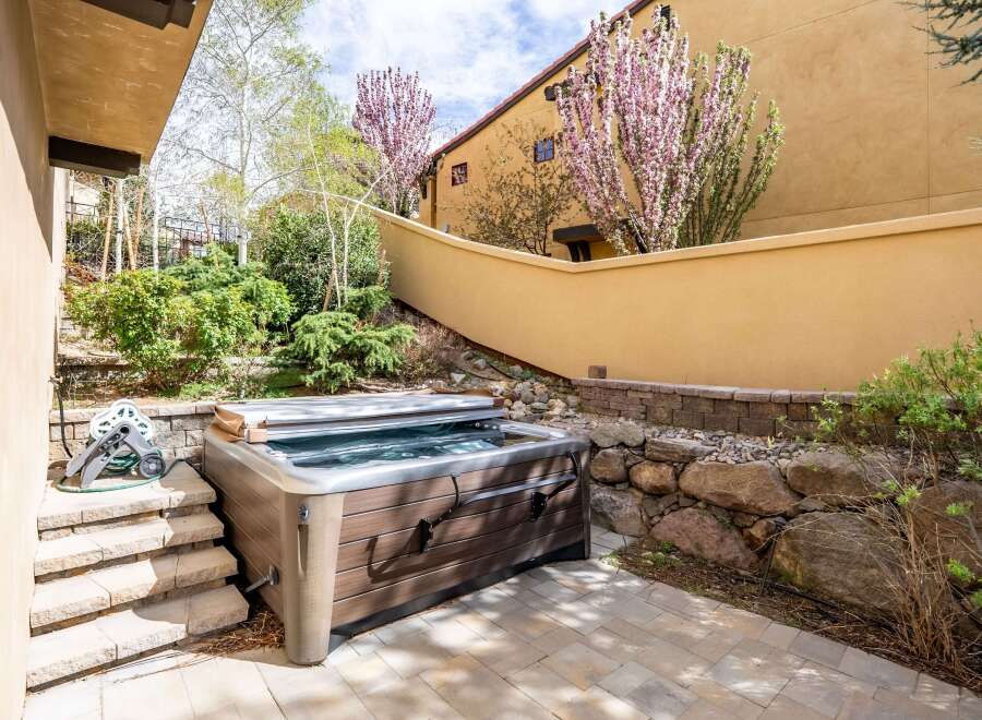 Enjoy luxurious relaxation in this stunning outdoor hot tub oasis.