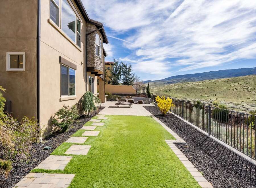 Enjoy the beauty of this stunning property featuring a meticulously landscaped backyard.