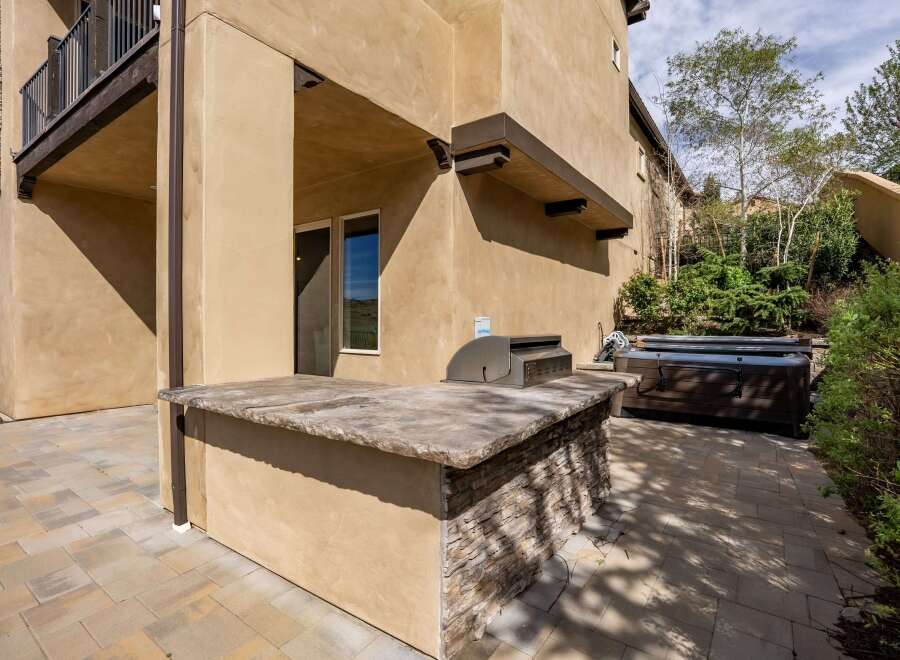 Enjoy outdoor living at its finest with this stunning property featuring a built-in outdoor kitchen, perfect for entertaining.