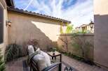 Enjoy the tranquility of this private outdoor oasis! This stunning patio features comfortable seating, a charming table, and lush greenery, perfect for relaxing or entertaining.