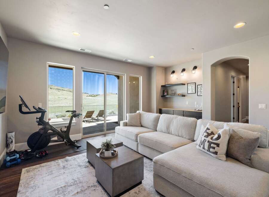 Experience luxury living in this stunning property! This home boasts a spacious living area with a modern Peloton bike, perfect for staying active.