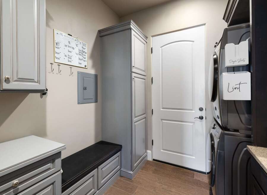 This laundry room boasts a sleek and functional design, perfect for modern living.