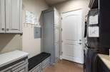 This laundry room boasts a sleek and functional design, perfect for modern living.