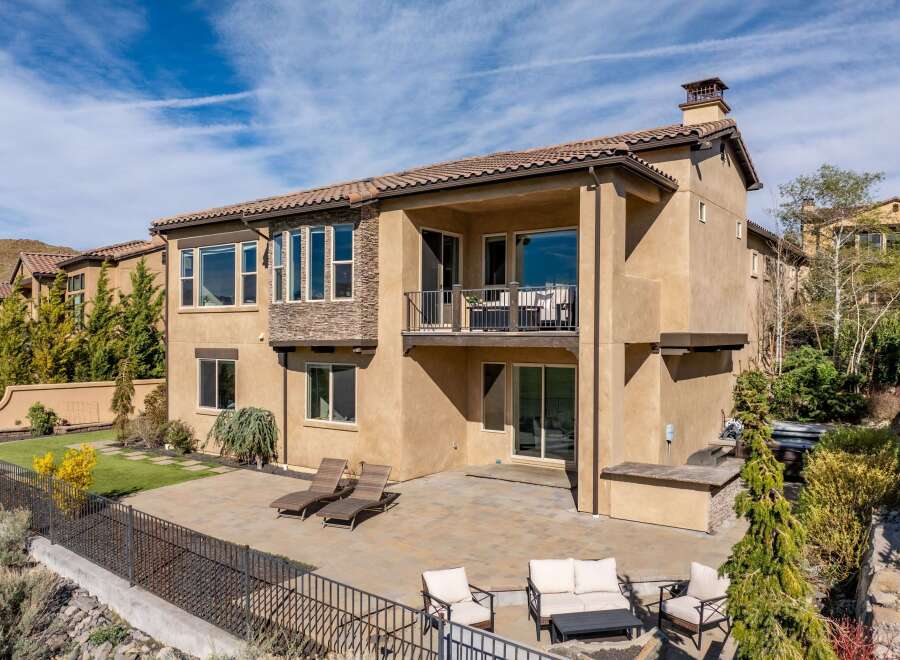 This stunning property boasts a beautiful exterior with a spacious patio and a second-floor balcony, perfect for outdoor relaxation and entertaining.