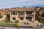 This stunning property boasts a luxurious design with a beautiful tile roof and a spacious patio, perfect for outdoor entertaining.