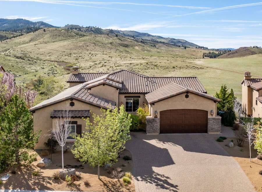 This stunning property boasts a beautiful exterior with a well-maintained driveway and lush landscaping.