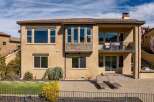 Discover luxury living in this stunning two-story home, featuring a beautiful stone facade and a tiled roof.