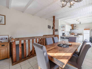 This charming property boasts a rustic dining area, perfect for family gatherings.