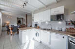 This charming kitchen boasts a bright and airy atmosphere, perfect for culinary endeavors.