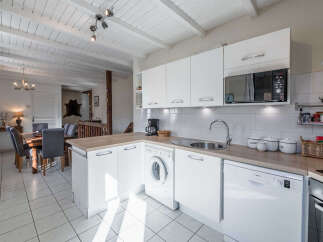 This charming kitchen boasts a bright and airy atmosphere, perfect for culinary endeavors.