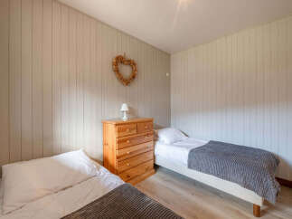 This cozy bedroom features two twin beds, perfect for guests or a shared living space.