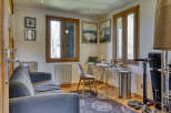 This charming property boasts a versatile space, perfect for both work and relaxation.