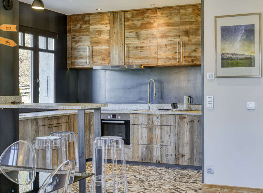 This stunning kitchen boasts rustic charm with its wooden cabinetry and granite countertops, creating a warm and inviting atmosphere.