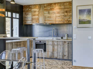 This stunning kitchen boasts rustic charm with its wooden cabinetry and granite countertops, creating a warm and inviting atmosphere.