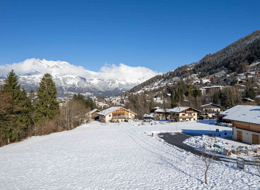 Nestled in a picturesque winter wonderland, this charming property offers stunning views of snow-capped mountains and a serene village.