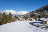 Nestled in a picturesque winter wonderland, this charming property offers stunning views of snow-capped mountains and a serene village.