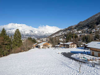 Nestled in a picturesque winter wonderland, this charming property offers stunning views of snow-capped mountains and a serene village.