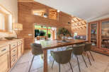 This stunning dining room showcases a beautiful wooden table and stylish chairs, perfect for hosting gatherings.