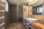 This modern bathroom features a sleek design with a walk-in shower and a stylish vanity.