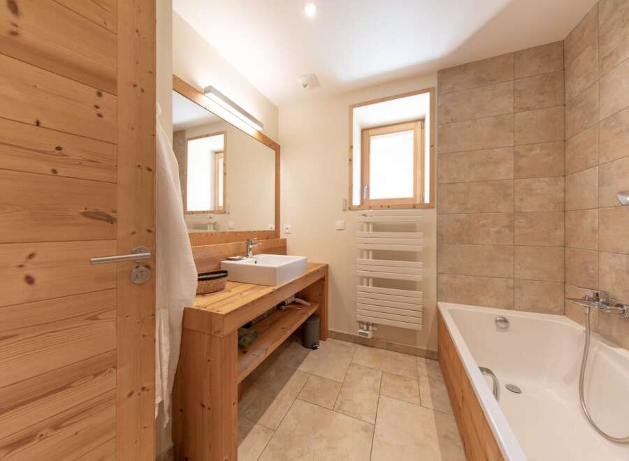 This stunning bathroom features a modern design with natural wood elements, creating a warm and inviting atmosphere.