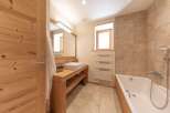 This stunning bathroom features a modern design with natural wood elements, creating a warm and inviting atmosphere.