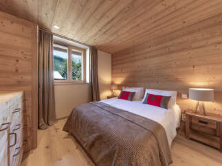 Experience the warmth of this inviting bedroom, featuring stunning wood paneling on the walls and ceiling.