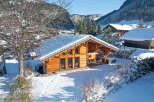 Discover a charming chalet nestled in a winter wonderland, offering a cozy retreat with stunning mountain views.