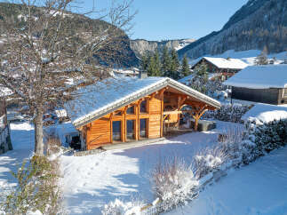 Discover a charming chalet nestled in a winter wonderland, offering a cozy retreat with stunning mountain views.