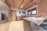 This stunning kitchen boasts a rustic charm with its wooden beams and cabinetry, creating a warm and inviting atmosphere.