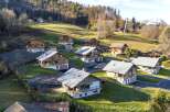 Discover a charming collection of chalets nestled in a picturesque mountain setting.